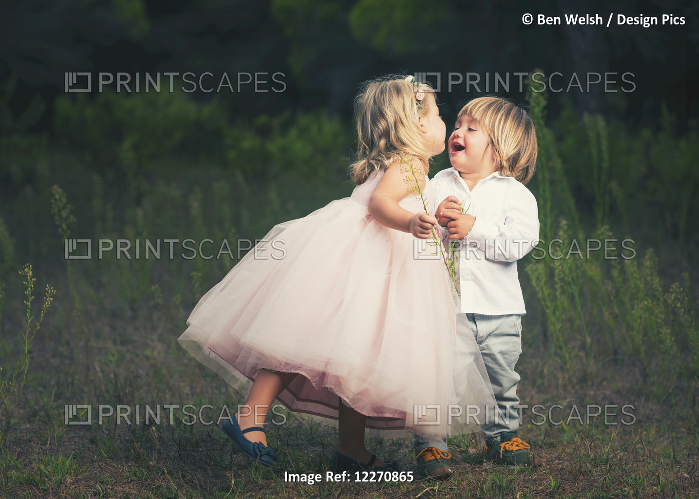 A Young Girl With A Pink Princess Dress Leans In To Kiss A Young Boy; Tarifa, ...