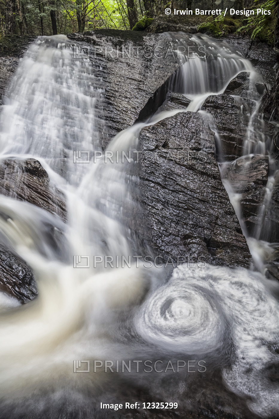 A Waterfall Cascading Over Rocks In A Forest; Middle Sackville, Nova Scotia, ...