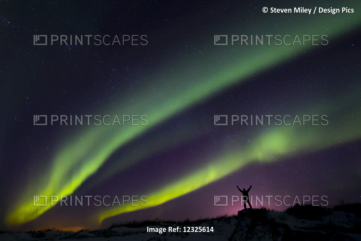 Colourful Aurora Borealis Over A Man With Arms Outstretched Silhouetted Against ...