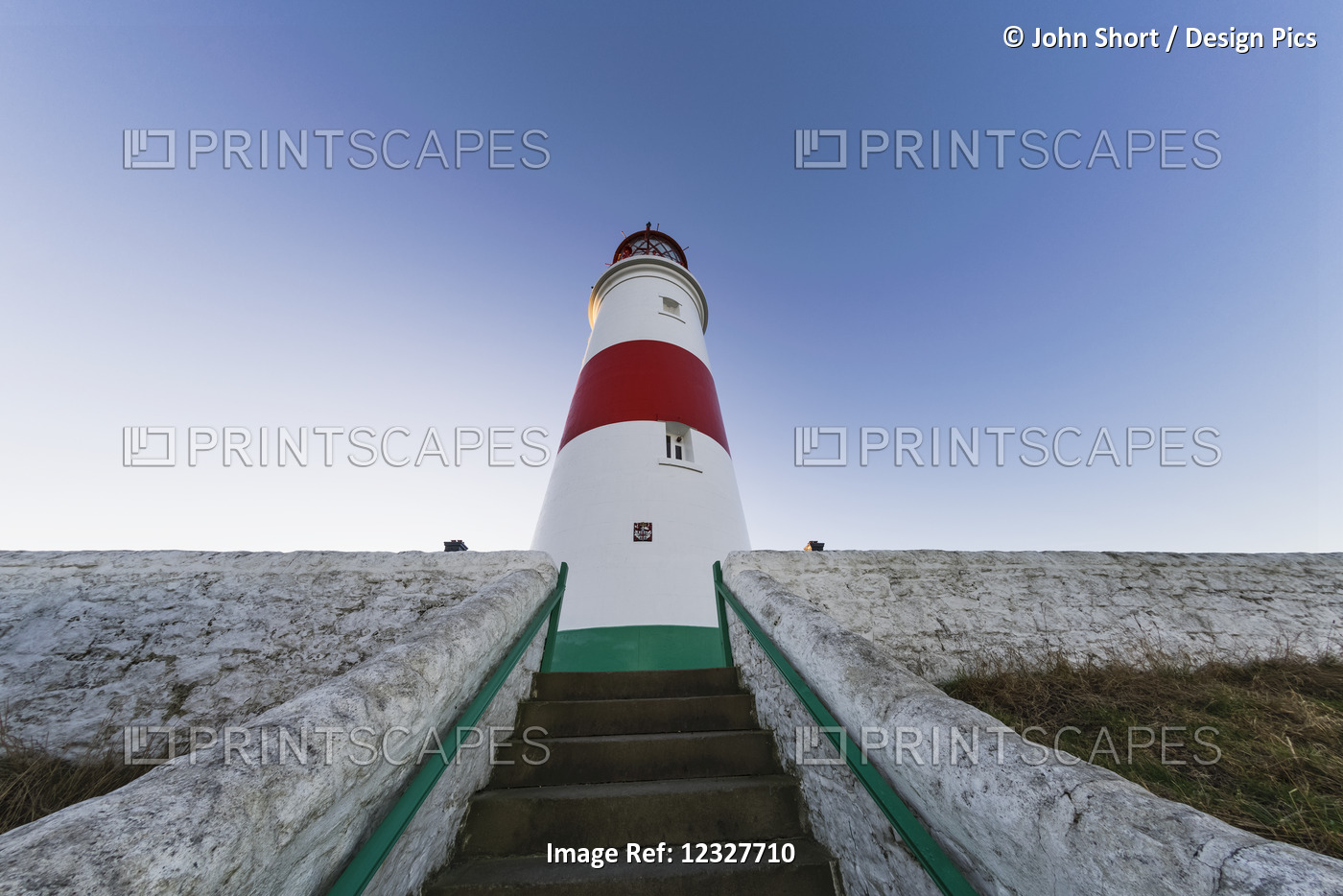 Low Angle View Of Steps Leading To A Lighthouse Against A Blue Sky; South ...