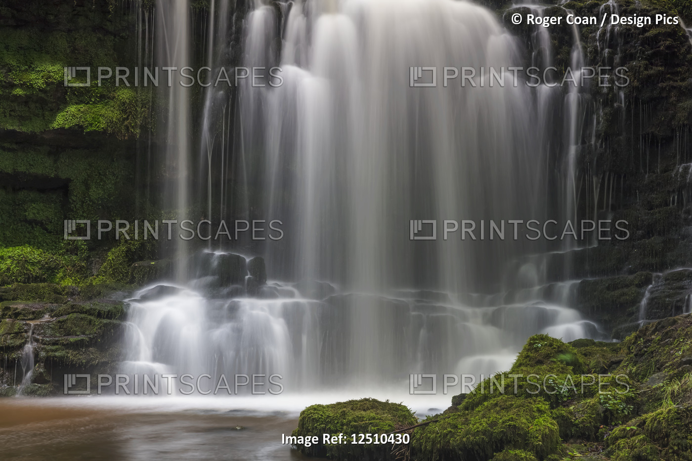 Numerous waterfalls flowing over rocks into a pool in the Yorkshire Dales; ...